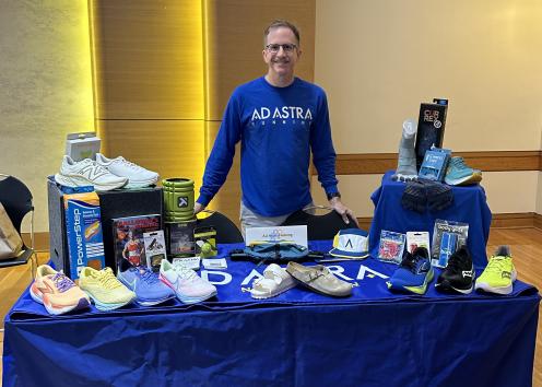 Employee from Ad Astra Running behind a table with running gear