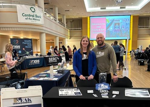 Employees from Peak Performance Chiropractic stand behind their table